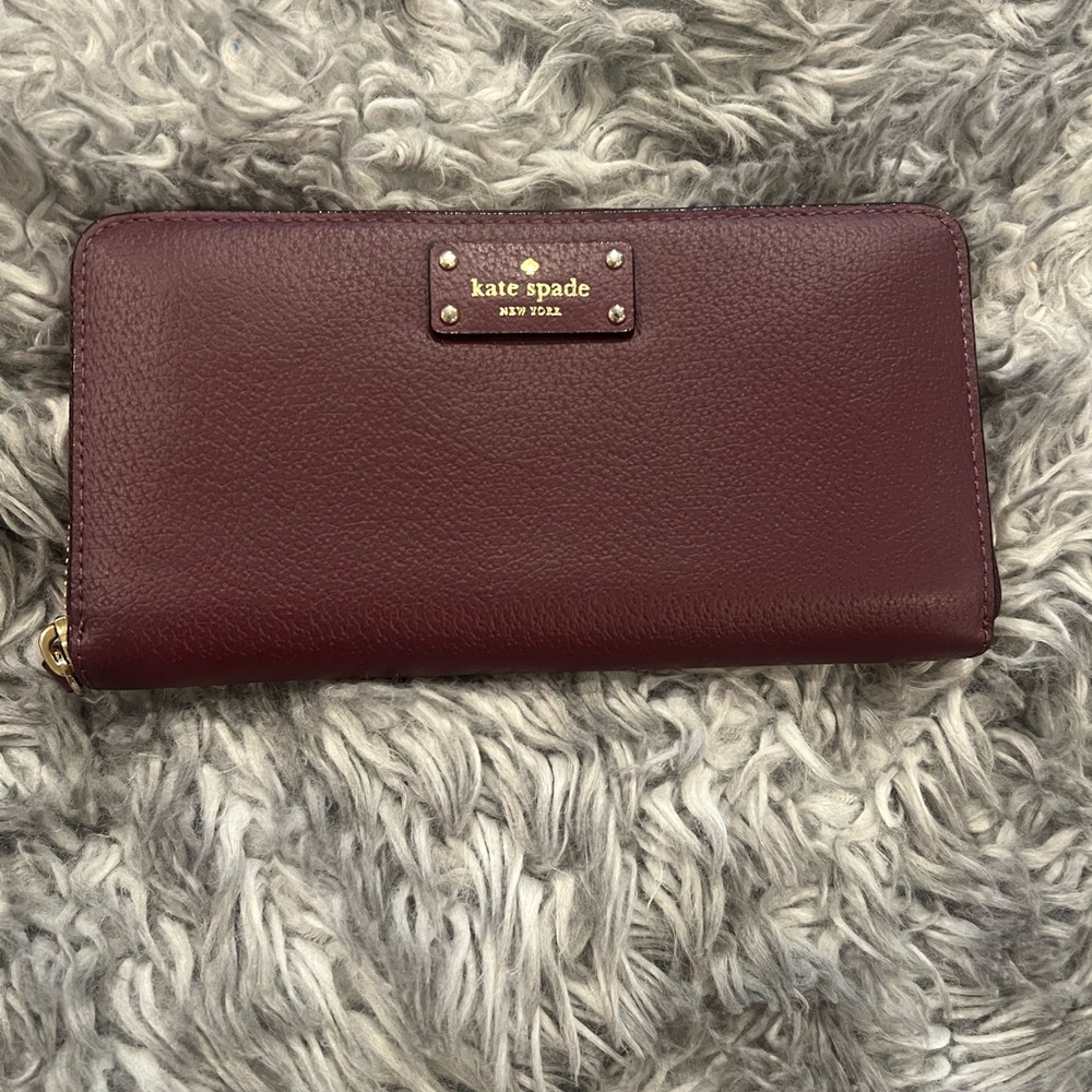 kate spade Burgundy Leather Zip-Around Wallet with Gold Logo